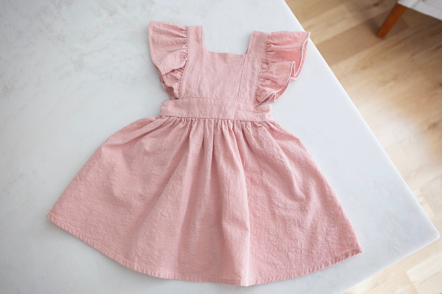 Blush Pink Baby Dress with ruffle sleeves and back bow - Cheerful Lane